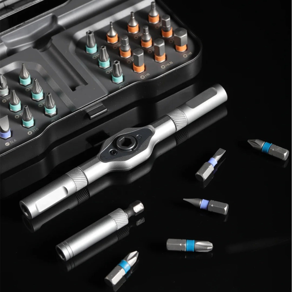 Macro photograph of the open RS1 pocket case, forged pass-through T-handle, and color-coded S2 alloy steel bits