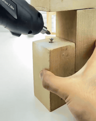Owner handheld clip showing a bulky cordless drill blocked by a narrow wooden bracket gap while the AXVANE ratchet fits inside
