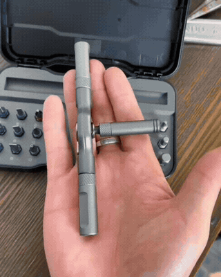 Real owner handheld clip sliding the forged aluminum bar through the ratchet head