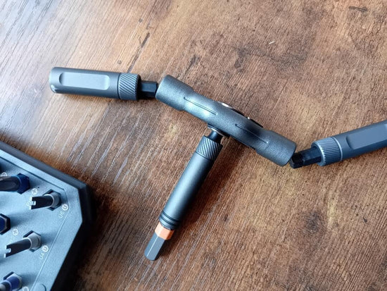 3-piece forged aluminum RS1 ratchet handle with orange H6 bit on wooden desk