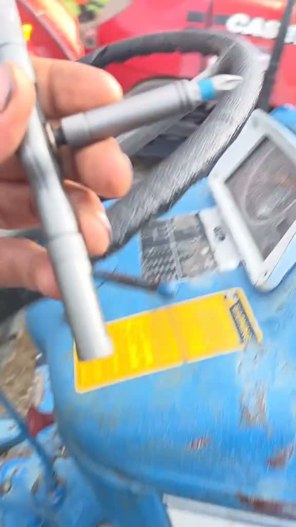 Holding the RS1 T-handle with blue Phillips S2 bit inside truck cab